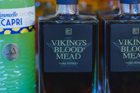 Bottles of Viking's Blood Mead with a visible brand logo on a blurred background.
